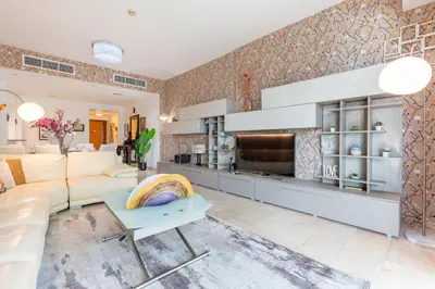 a living room with a couch and a table at Few Metres from Marina Beach, Arabian Gulf Views - Trident Grand Residences, Dubai Marina by Deluxe Holiday Homes in Dubai