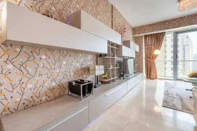 a kitchen with white cabinets and a patterned wall at Few Metres from Marina Beach, Arabian Gulf Views - Trident Grand Residences, Dubai Marina by Deluxe Holiday Homes in Dubai