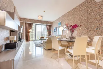 a dining room and living room with a table and chairs at Few Metres from Marina Beach, Arabian Gulf Views - Trident Grand Residences, Dubai Marina by Deluxe Holiday Homes in Dubai
