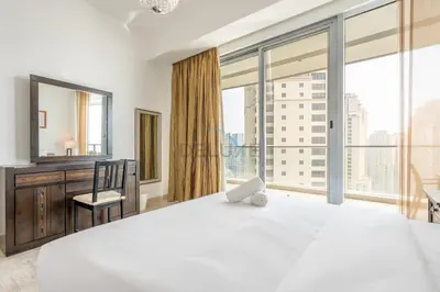 a bedroom with a large bed and a large window at Few Metres from Marina Beach, Arabian Gulf Views - Trident Grand Residences, Dubai Marina by Deluxe Holiday Homes in Dubai