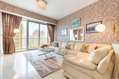 a living room with a couch and a table at Few Metres from Marina Beach, Arabian Gulf Views - Trident Grand Residences, Dubai Marina by Deluxe Holiday Homes in Dubai