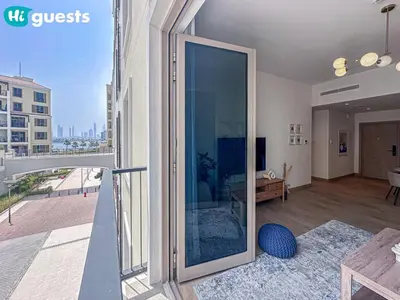 a sliding glass door in a living room with a view at HiGuests - Breezy 1 BR Retreat Near La Mer Beach in Dubai