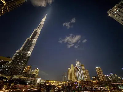 a view of a city at night with the tallest building at Full Burj Khalifa and Fountain View from All Rooms in Dubai