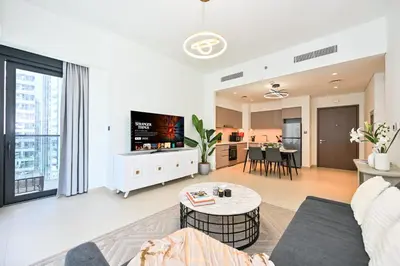 a living room with a couch and a table at Majestic Act2 1BR Dowtown Dubai in Dubai