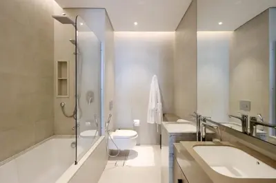 a bathroom with two sinks and a toilet and a shower at Livbnb Beachfront 2BR in Address JBR Sea & Ain Dubai Views in Dubai