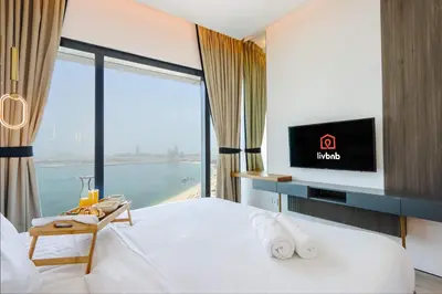 a hotel room with a bed and a large window at Livbnb Beachfront 2BR in Address JBR Sea & Ain Dubai Views in Dubai