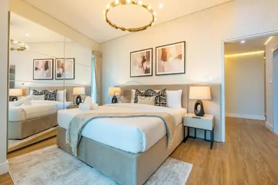 a bedroom with a large bed and a mirror at High-Floor 2BR with Pool and City Views, Near Tram Station and Dubai Marina Walk, Marina Heights, Dubai Marina by Deluxe Holiday Homes in Dubai