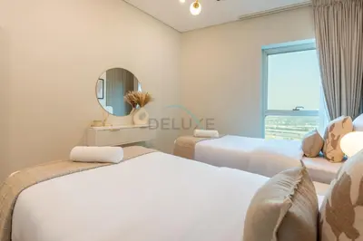 a bedroom with two beds and a mirror at High-Floor 2BR with Pool and City Views, Near Tram Station and Dubai Marina Walk, Marina Heights, Dubai Marina by Deluxe Holiday Homes in Dubai