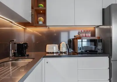 a kitchen with a sink and a microwave at Novity Signature Homes in Dubai