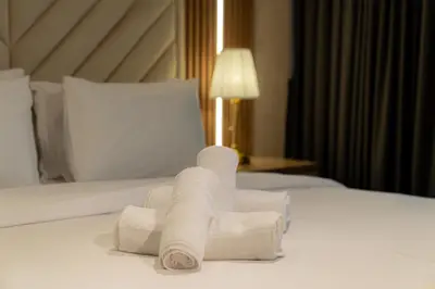 a pile of towels sitting on top of a bed at Trendy & Cozy Getaway in Dubai