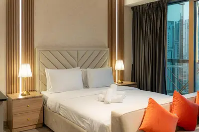 a hotel room with a bed with a teddy bear on it at Trendy & Cozy Getaway in Dubai