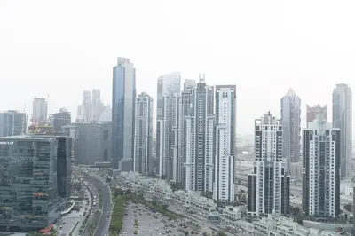 a city skyline with tall buildings and a freeway at Trendy & Cozy Getaway in Dubai