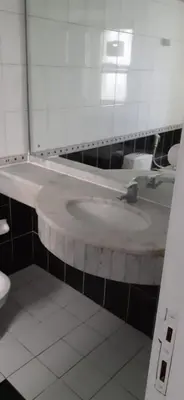 a bathroom with a white sink and a mirror at hostel in Dubai