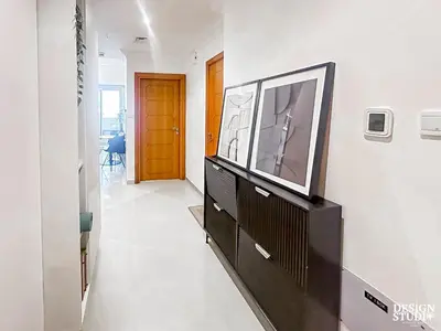 a living room with a flat screen tv on a dresser at DREAM by Design Studio in Dubai