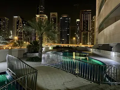 a swimming pool with a city skyline at night at DREAM by Design Studio in Dubai