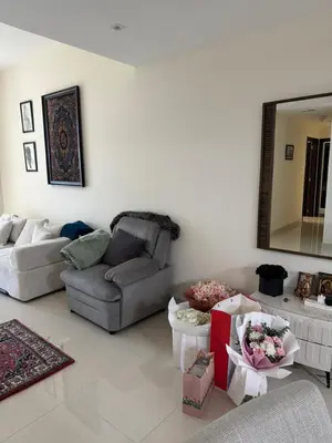 a living room with a couch and a mirror at Affordable master bedroom hotel apartment in Dubai