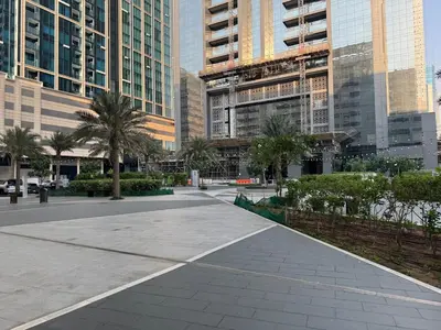 a walkway in a city with tall buildings at Stylish 2BHK in Prime Location in Dubai