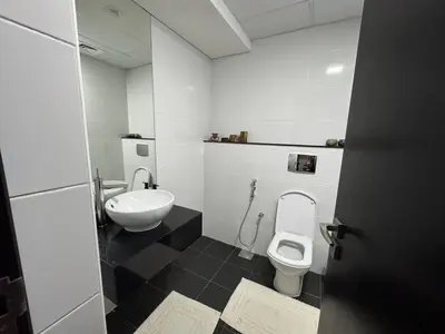 a bathroom with a toilet and a sink at Stylish 2BHK in Prime Location in Dubai
