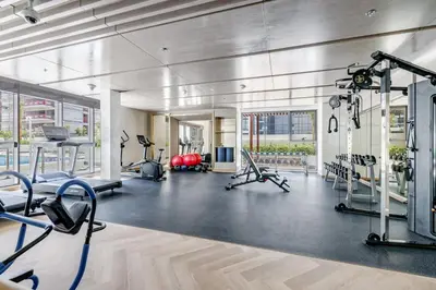 a gym with several treadmills and exercise bikes at GLOBALSTAY Azizi Riviera 59 in Dubai