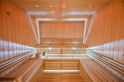 an empty sauna with wooden paneling and lights at Luxury 3BR Full Burj Khalifa View Stay by World's Tallest Tower in Dubai