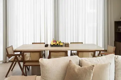 a dining room table with a bowl of fruit on it at Seraya at Residence 110 in Dubai