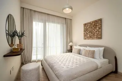 a bedroom with a large bed and a large window at Seraya Residence 7 - 4BDR - Burj and DIFC skyline Views in Dubai