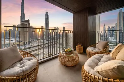 a balcony with chairs and a view of a city at Seraya Residence 7 - 4BDR - Burj and DIFC skyline Views in Dubai