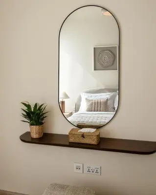 a mirror on a shelf with a bed at Seraya Residence 9 - 4BDR - Skyline and Burj View - 3 Balconies in Dubai