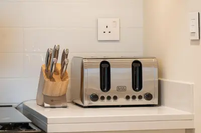 a kitchen counter with a toaster and a knife block at Seraya Residences at Forte in Dubai