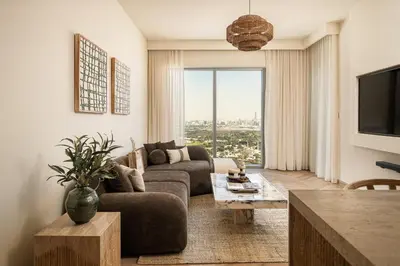 a living room with a couch and a tv at Seraya Residences at Downtown Views 2 in Dubai