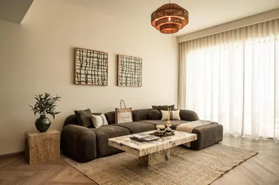 a living room with a couch and a coffee table at Seraya Residences at Downtown Views 2 in Dubai