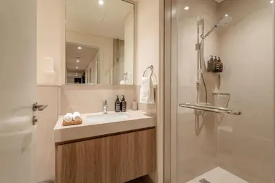 a bathroom with a sink and a shower at Seraya Residence 11 - 3BDR - Private Jacuzzi and Infrared Sauna in Dubai