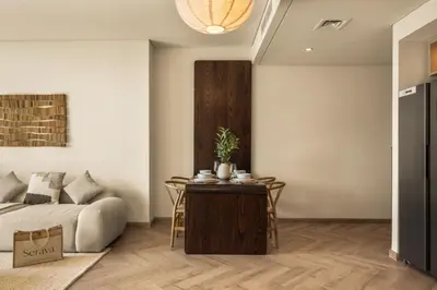 a living room with a couch and a table at Seraya Residences at Burj Crown in Dubai
