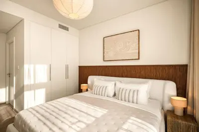 a bedroom with a large white bed with white pillows at Seraya Residences at Burj Crown in Dubai