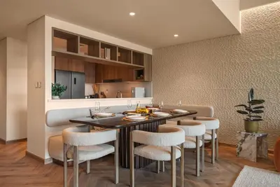 a kitchen and dining room with a table and chairs at Seraya Residence 14 - 4 BDR - Burj Views - Big Balcony in Dubai