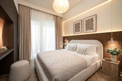 a bedroom with a large white bed and a window at Seraya Residence 12 - 3BDR - Hot Tub on patio with Burj view in Dubai