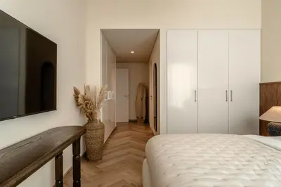 a bedroom with a bed and a television on a wall at Seraya Residence 15 - 3BDR - Burj View and Dubai Mall access in Dubai