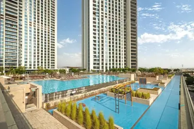 an overhead view of a swimming pool with two tall buildings at Seraya Residence 15 - 3BDR - Burj View and Dubai Mall access in Dubai