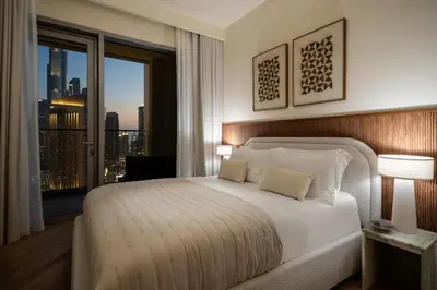 a bedroom with a large bed and a large window at Seraya Residence 15 - 3BDR - Burj View and Dubai Mall access in Dubai