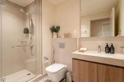 a bathroom with a toilet and a sink and a shower at Seraya Residence 15 - 3BDR - Burj View and Dubai Mall access in Dubai