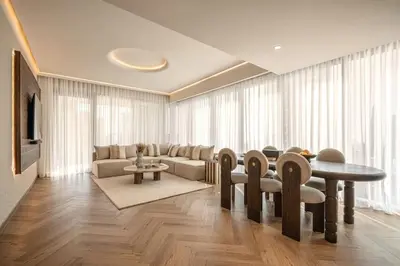 a living room with a table and chairs at Seraya Residence 15 - 3BDR - Burj View and Dubai Mall access in Dubai