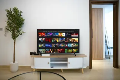 a flat screen tv sitting on top of a white cabinet at New Contemporary Lux and Pool & Kids Amenities in JVC in Dubai