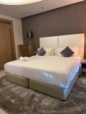 a bedroom with a large white bed in a room at Royal Montania by DAMAC Paramount , Burj Khalifa View in Dubai