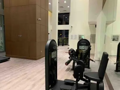 a gym with several exercise equipment in a building at Dubai Skyline & Creek View - Homeyvillas in Dubai