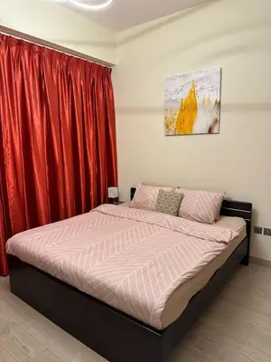 a bedroom with a bed with a red curtain at Dubai Skyline & Creek View - Homeyvillas in Dubai