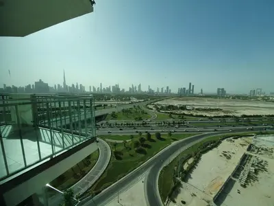 a view of a highway with a city in the background at Dubai Skyline & Creek View - Homeyvillas in Dubai