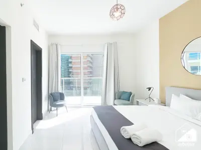 a white bedroom with a bed and a window at Amazing Stay in AG Tower , Business bay in Dubai