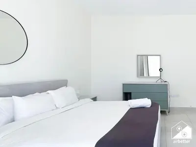 a bedroom with a white bed and a blue dresser at Amazing Stay in AG Tower , Business bay in Dubai