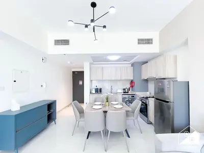 a kitchen and dining room with a table and chairs at Luxury At AG Tower Business Bay & City Views in Dubai
