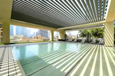 a swimming pool on the roof of a building at Skyline Gem Full Burj View 2BR Suite with Dubai Mall access by Maxx Value homes in Dubai